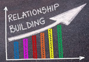 67016848 - relationship building written with chalk on tarmac over colorful graph and rising arrow, business marketing and creativity concept